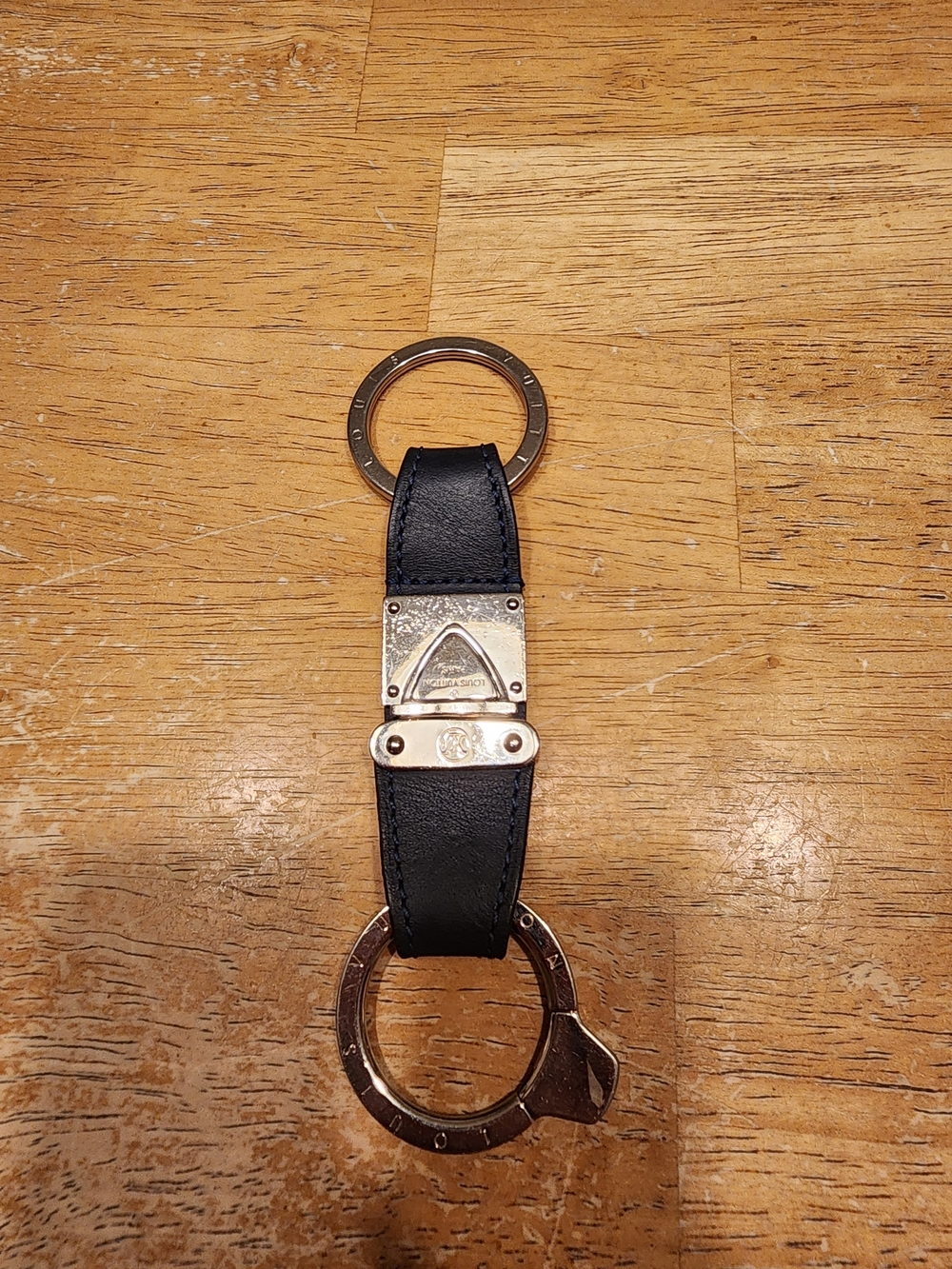 Louis Vuitton black leather valet key chain featuring silver-tone metal hardware